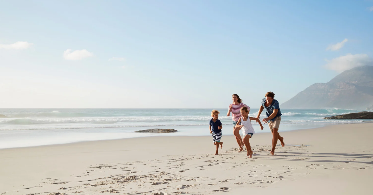 Family running on beach 