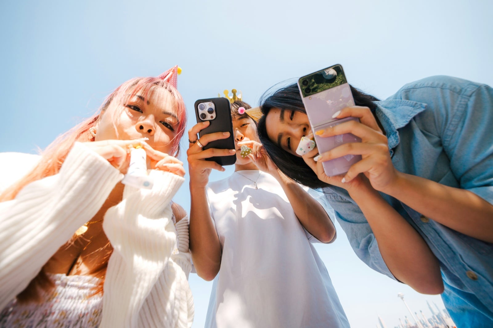 Members taking selfies on their phones