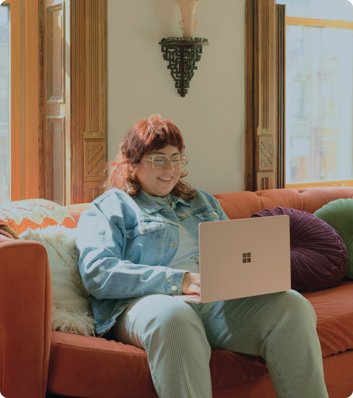 Woman relaxing on a couch with a laptop